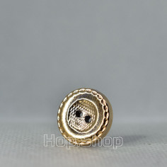 Gold glossy plastic button with a pattern